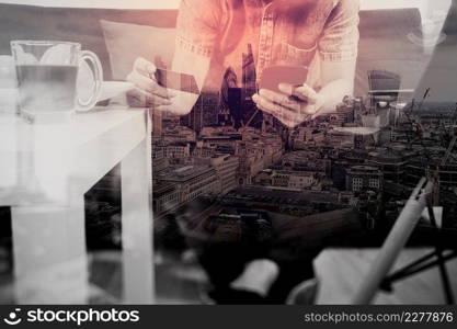 double exposure of hipster hand using smart phone,digital tablet docking keyboard,holding credit card payments online business,sitting on sofa in living room,work at home,London architecture city