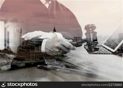 double exposure of justice and law concept.Male judge in a courtroom with the gavel,working with digital tablet computer docking keyboard on wood table,eyeglass,London architecture city