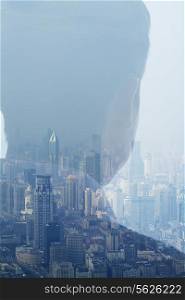 Double exposure of man over cityscape, rear view