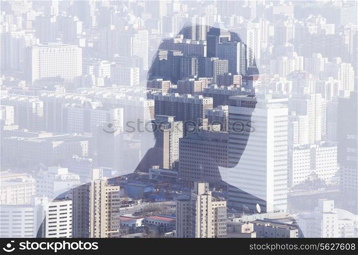 Double exposure of man over cityscape, rear view