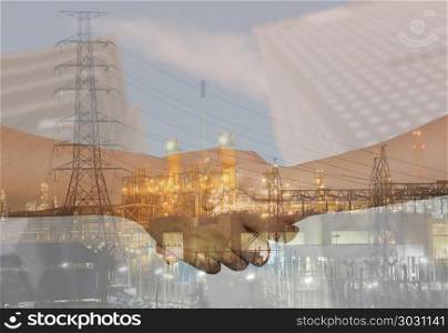 Double Exposure of Oil refineries and business handshakes join h. Double Exposure of Oil refineries and business handshakes join hands in concept of negotiation and presentation.