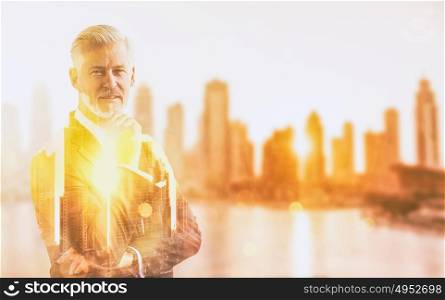 Double exposure of senior businessman in front of the big city
