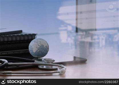 double exposure of stethoscope and texture globe with digital tablet as medical network concept