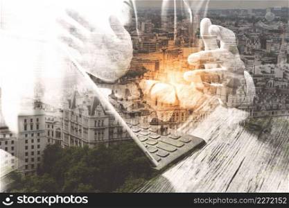 Double exposure of success businessman using eyeglass,digital tablet docking smart keyboard  with London building,city,filter effect
