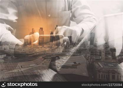 Double exposure of success businessman using smart phone,digital tablet docking smart keyboard  with London building,city,omnichannel