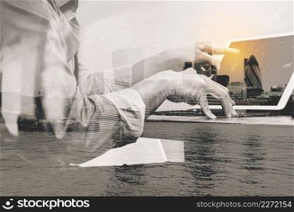 Double exposure of success businessman using smart phone,digital tablet docking smart keyboard  with London building,city,thames river