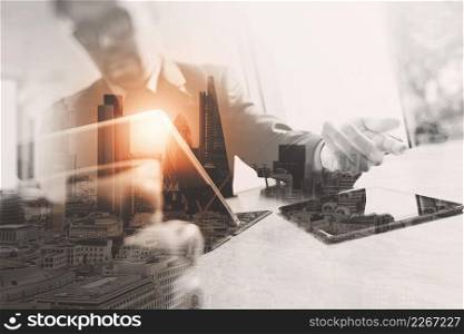 Double exposure of success businessman working in office with digital tablet laptop computer with London building and smart phone,filter effect