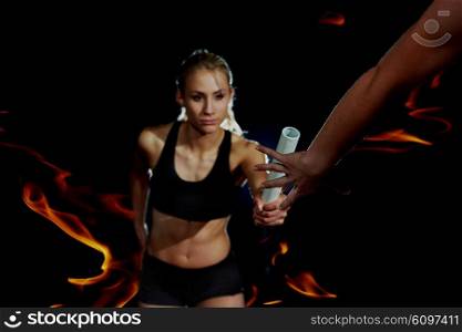 double exposure of woman and fire in background, athletic runners passing baton in relay race