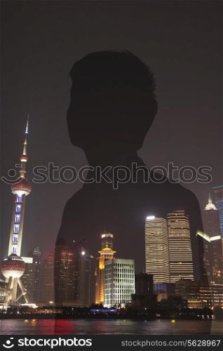Double exposure of young businessman and the cityscape of Shanghai, China