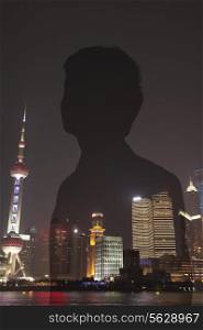 Double exposure of young businessman and the cityscape of Shanghai, China