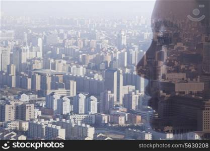 Double exposure of young woman&rsquo;s face over cityscape, side view
