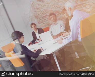 Double exposure with low poly design. Business people group on meeting at modern bright office indoors. Senior businessman as leader in discussion.