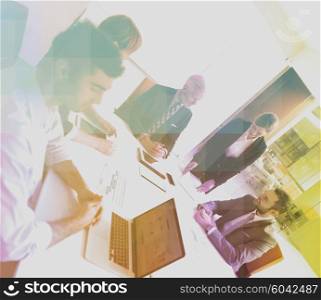 Double exposure with low poly design. Business people group on meeting at modern bright office indoors. Senior businessman as leader in discussion.