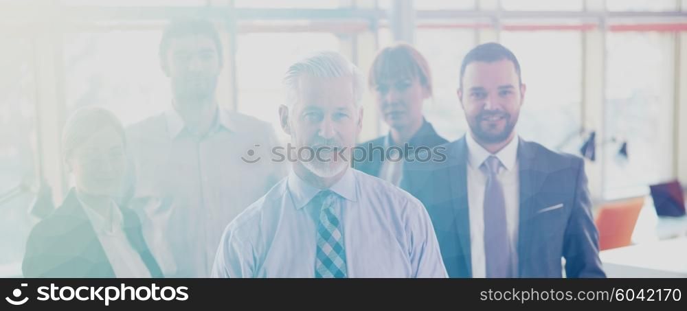 Double exposure with low poly design. Senior businessman with his team at office. business people group