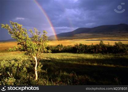 Double rainbow .Sunshine in the mountain farm.