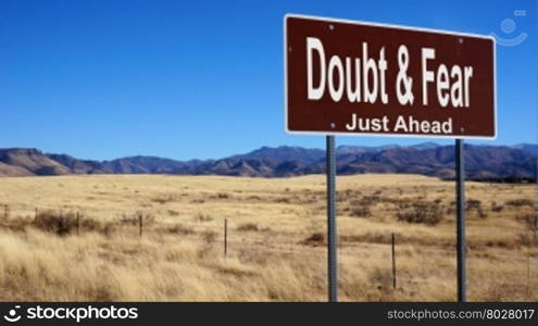 Doubt and Fear road sign with blue sky and wilderness