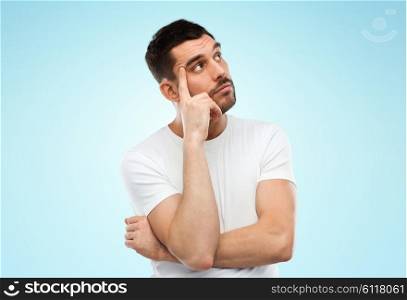 doubt, expression and people concept - man thinking over blue background