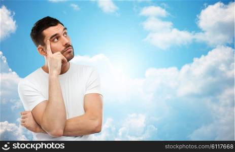 doubt, expression and people concept - man thinking over blue sky and clouds background