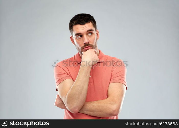 doubt, expression and people concept - man thinking over gray background