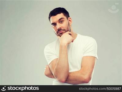 doubt, expression and people concept - man thinking over gray background. man thinking over gray background