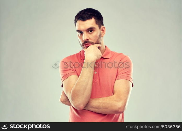 doubt, expression and people concept - serious man thinking over gray background. man thinking over gray background