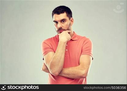 doubt, expression and people concept - serious man thinking over gray background. man thinking over gray background