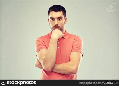 doubt, expression and people concept - serious man thinking over gray background. man thinking over gray background. man thinking over gray background