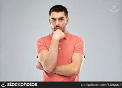doubt, expression and people concept - serious man thinking over gray background