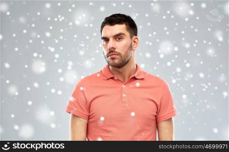 doubt, expression, winter, christmas and people concept - suspicious man thinking over snow on gray background