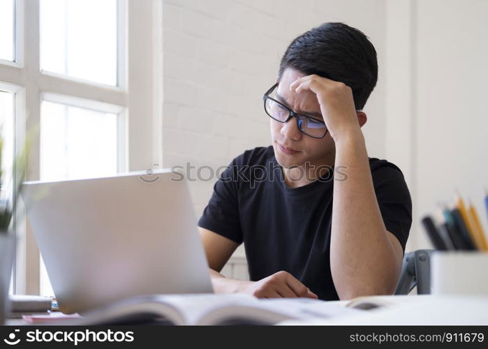 Doubt student working on homework or research work. Thoughtful pensive serious male student thinking about project analysing planning making decision concept.