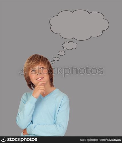 Doubtful preteen boy thinking on gray background
