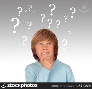 Doubtful preteen boy with many question symbols isolated on a over white background