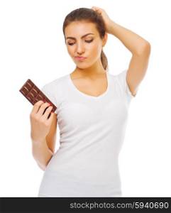 Doubting young girl with chocolate isolated