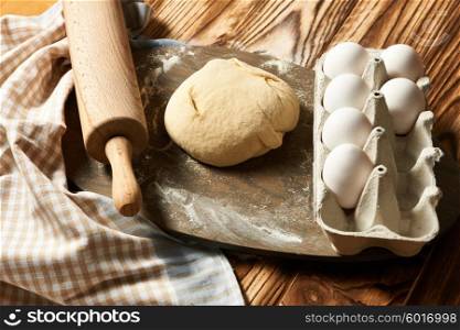 Dough and ingredients on wooden table