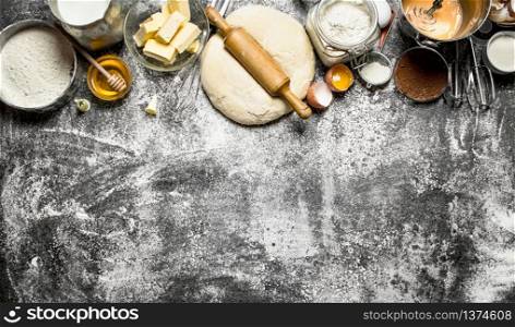Dough background. Fresh dough with a variety of ingredients on rustic background.