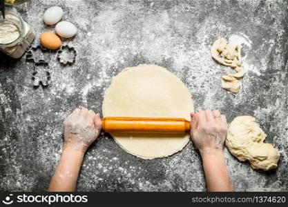 Dough background. The rolling of the hands of women for cookies. On rustic background.. Dough background. The rolling of the hands of women for cookies.