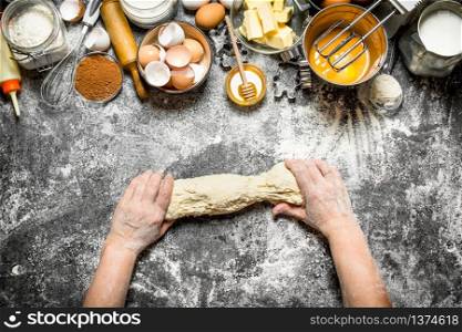 Dough background. Woman kneads dough with various ingredients on the table. On rustic background .. Dough background. Woman kneads dough with various ingredients on the table.