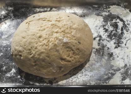 Dough in the pan and flour