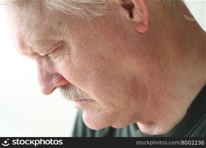 Downcast senior man with an expression of sadness, depression or grief