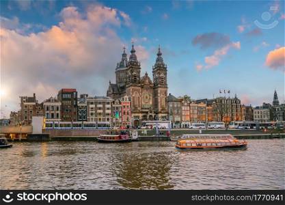 Downtown Amsterdam city skyline. Cityscape in Netherlands at sunset