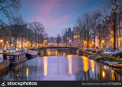 Downtown Amsterdam city skyline. Cityscape in Netherlands at sunset