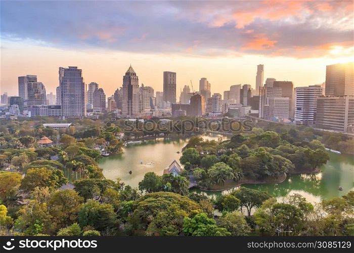 Downtown Bangkok city skyline with Lumpini park from top view in Thailand at sunset