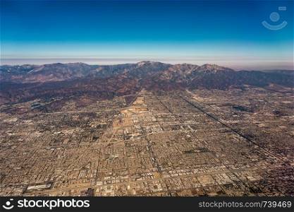 downtown los angeles skyline and suburbs from airplane and smoke from wild fires