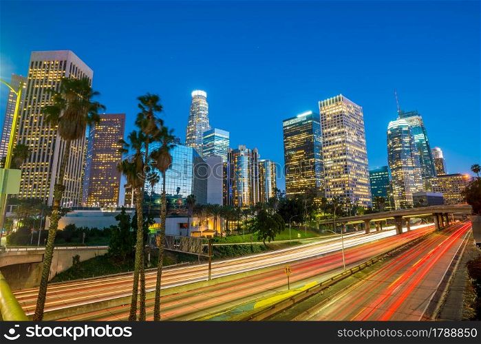 Downtown Los Angeles skyline during rush hour at twilight