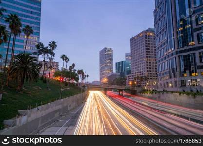 Downtown Los Angeles skyline during rush hour at twilight