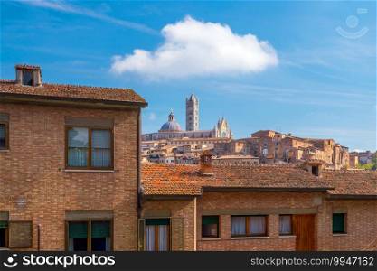 Downtown Siena skyline in Italy with blue sky