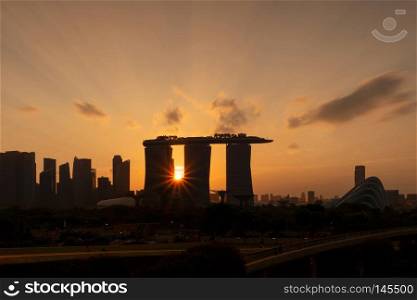 Downtown Singapore city in Marina Bay area. Financial district and skyscraper buildings. Aerial view at sunset.