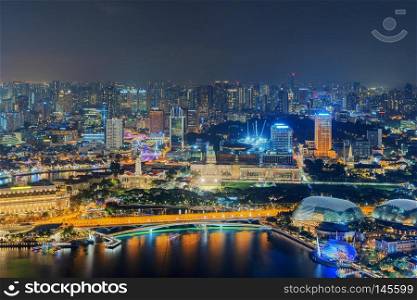 Downtown Singapore City in Marina Bay area. Financial district and skyscraper buildings. Aerial view  at night.