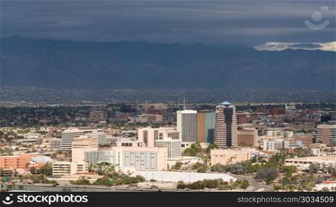 Downtown Tucson in Arizona with storm clouds. Downtown area of Tucson in Arizona with the sun lighting the buildings while storm clouds gather over distant mountain range. Downtown Tucson in Arizona with storm clouds