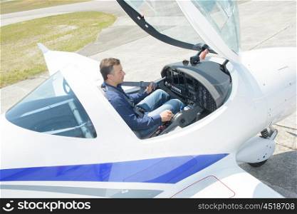 Downward view of man in cockpit of aircraft